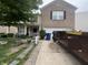 Two-story home featuring a brick facade, attached garage, well-kept lawn and trash dumpsters in driveway at 12509 Teacup Way, Indianapolis, IN 46235