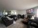 Open concept living room showcasing modern furniture and a stone fireplace at 12509 Teacup Way, Indianapolis, IN 46235