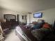 A spacious bedroom with a bed, dresser, TV, and a ceiling fan at 12509 Teacup Way, Indianapolis, IN 46235