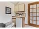 Compact bar area featuring a mini fridge and upper cabinets at 13153 Tudor Dr, Carmel, IN 46033
