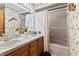 Traditional bathroom with double vanity, floral wallpaper, and enclosed shower at 13153 Tudor Dr, Carmel, IN 46033