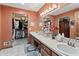 En suite bathroom with double vanity, large mirror and decor lighting at 13153 Tudor Dr, Carmel, IN 46033