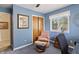 Cozy bedroom with blue walls, chair, artwork, and natural light from the window at 13153 Tudor Dr, Carmel, IN 46033