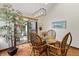 Elegant dining area with wicker chairs, plants, and sliding glass doors opening to the outside at 13153 Tudor Dr, Carmel, IN 46033