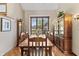 Sunlit dining room featuring a classic wood table, chairs, and a display cabinet at 13153 Tudor Dr, Carmel, IN 46033