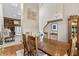 Charming dining room showcasing an elegant light fixture and staircase at 13153 Tudor Dr, Carmel, IN 46033