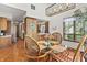 Cozy dining area with wicker chairs, glass table, and a view into the adjacent kitchen at 13153 Tudor Dr, Carmel, IN 46033