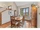 Traditional dining room with wood table, chairs, and cabinetry near a large window at 13153 Tudor Dr, Carmel, IN 46033