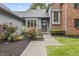 Inviting home entrance with a walkway leading to a beautiful flower garden at 13153 Tudor Dr, Carmel, IN 46033