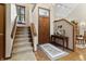 Inviting home entryway featuring wood door, staircase, console table, and lovely décor at 13153 Tudor Dr, Carmel, IN 46033