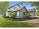 Exterior view of home with landscaping and gravel, light-grey siding at 13153 Tudor Dr, Carmel, IN 46033