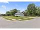 Corner lot home with mature trees, two car garage, and lush green yard at 13153 Tudor Dr, Carmel, IN 46033