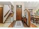 Entrance foyer with stairs, tile flooring, and dining area at 13153 Tudor Dr, Carmel, IN 46033