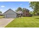 Charming home with two-car garage, concrete drive, lush lawn and landscaped front yard at 13153 Tudor Dr, Carmel, IN 46033