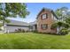 Charming home with manicured lawn, walkway, flower garden, and brick facade at 13153 Tudor Dr, Carmel, IN 46033
