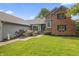 Charming home with manicured lawn, walkway, flower garden, and brick facade at 13153 Tudor Dr, Carmel, IN 46033