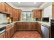 Traditional kitchen showcasing wood cabinets and tile floors at 13153 Tudor Dr, Carmel, IN 46033