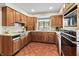 Classic kitchen with warm wood cabinets and updated appliances at 13153 Tudor Dr, Carmel, IN 46033