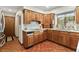 Well-lit kitchen featuring terracotta tile floors and wood cabinets at 13153 Tudor Dr, Carmel, IN 46033