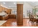 Open kitchen features wood cabinetry, tiled floor, and ample sunlight at 13153 Tudor Dr, Carmel, IN 46033