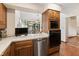 Well-lit kitchen featuring wood cabinets, a dishwasher, and modern appliances on a clean countertop at 13153 Tudor Dr, Carmel, IN 46033