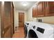 Laundry room features modern washer and dryer set, storage cabinets, and closet at 13153 Tudor Dr, Carmel, IN 46033