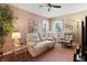 Comfortable living room with patterned wallpaper, plush seating, and ambient lighting at 13153 Tudor Dr, Carmel, IN 46033