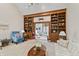 Spacious living room with built-in bookshelves and large opening to the next room at 13153 Tudor Dr, Carmel, IN 46033