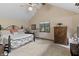 Inviting bedroom features a cozy bed, a ceiling fan, and two windows with outside views at 13153 Tudor Dr, Carmel, IN 46033