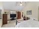 Well-appointed bedroom with comfortable sleeping area, wooden furniture, and large windows at 13153 Tudor Dr, Carmel, IN 46033