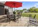 Outdoor patio with table and chairs and a red umbrella at 13153 Tudor Dr, Carmel, IN 46033