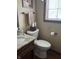 Compact bathroom featuring a pedestal sink and toilet at 13736 Langley Dr, Carmel, IN 46032