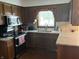 Functional kitchen featuring wood cabinetry and stone countertops at 13736 Langley Dr, Carmel, IN 46032