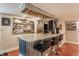 Entertainment basement featuring a custom wet bar with seating and storage at 1437 Shannon Ave, Indianapolis, IN 46201