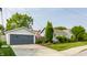 Well-manicured front exterior featuring attached garage and traditional landscaping at 1437 Shannon Ave, Indianapolis, IN 46201