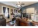 Inviting home office featuring a dark wood desk, Peloton bike, and thoughtful decor at 1437 Shannon Ave, Indianapolis, IN 46201