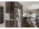 Modern kitchen featuring stainless steel refrigerator, granite countertop island, and hardwood floors at 1437 Shannon Ave, Indianapolis, IN 46201