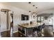 Kitchen island featuring a granite countertop, stainless steel microwave, and barstool seating at 1437 Shannon Ave, Indianapolis, IN 46201
