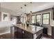 Kitchen island with granite countertop with seating and stainless steel microwave at 1437 Shannon Ave, Indianapolis, IN 46201