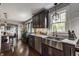 Open kitchen layout with stainless steel appliances, custom cabinets, and a large farmhouse sink at 1437 Shannon Ave, Indianapolis, IN 46201
