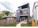 Inviting modern home exterior with a balcony, a small fenced yard, and modern design at 1452 Fletcher Ave, Indianapolis, IN 46203
