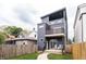 Inviting modern home exterior with a balcony, a small fenced yard, and modern design at 1452 Fletcher Ave, Indianapolis, IN 46203