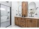Modern bathroom featuring a dual sink vanity, sleek wood cabinets, and a glass-enclosed shower with separate tub at 1452 Fletcher Ave, Indianapolis, IN 46203