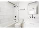 Clean bathroom with a bathtub, subway tile, and a white vanity with black fixtures at 1452 Fletcher Ave, Indianapolis, IN 46203