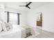 Bedroom featuring soft decor, ceiling fan, and ensuite bathroom with wood cabinets at 1452 Fletcher Ave, Indianapolis, IN 46203