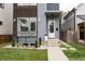Elegant front entrance with modern fixtures, a white door, and a landscaped garden at 1452 Fletcher Ave, Indianapolis, IN 46203