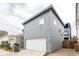 Exterior view of a garage with light gray siding, a white garage door, and neat landscaping at 1452 Fletcher Ave, Indianapolis, IN 46203