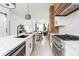 Open-concept kitchen with modern appliances, a large island, and a view into the dining and living area at 1452 Fletcher Ave, Indianapolis, IN 46203