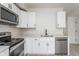Modern kitchen boasts stainless appliances, white cabinetry, and quartz countertops at 1452 Fletcher Ave, Indianapolis, IN 46203