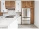 Close-up of kitchen with stainless steel refrigerator and modern white and wooden cabinets at 1452 Fletcher Ave, Indianapolis, IN 46203